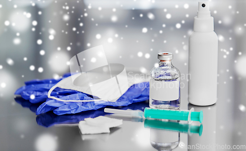 Image of syringe, medicine, wound wipes, gloves and mask