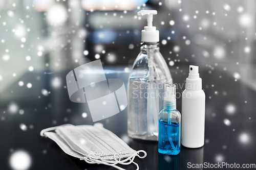 Image of hand sanitizers, medical masks and liquid soap