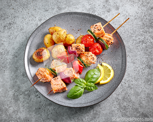 Image of grilled salmon skewers and vegetables