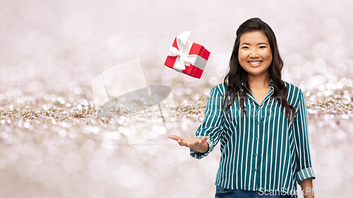 Image of happy asian woman with birthday present