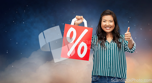 Image of asian woman with percentage sign on shopping bags