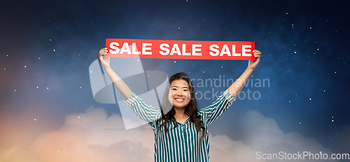 Image of happy smiling young asian woman with sale banner