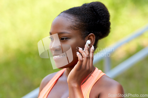 Image of happy african american woman with earphones