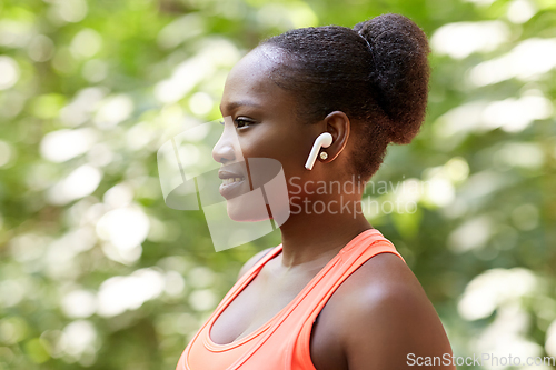 Image of happy african american woman with earphones