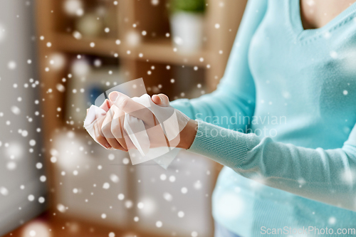 Image of woman cleaning hands with antiseptic wet wipe