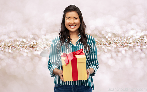 Image of happy asian woman with birthday present