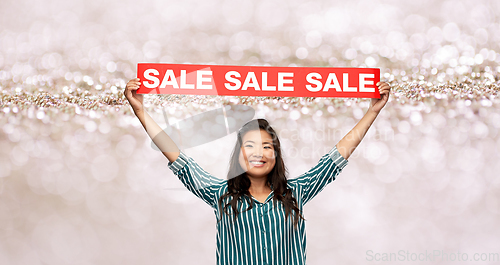 Image of happy smiling young asian woman with sale banner