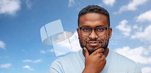 Image of portrait of african american in glasses over sky