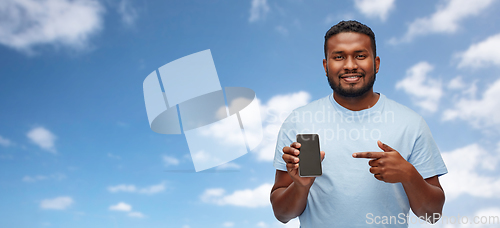 Image of african american man with smartphone over sky