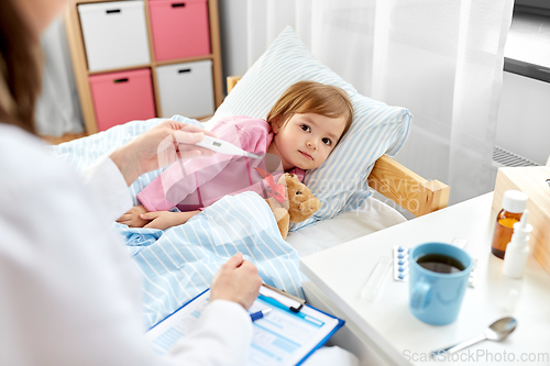 Image of doctor measuring sick girl's temperature