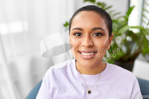 Image of portrait of happy african american woman at home