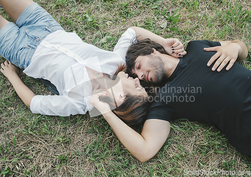 Image of Couple lying in the grass