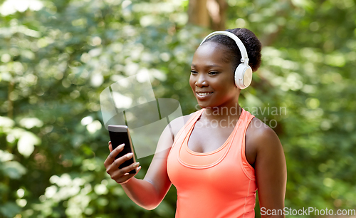 Image of african american woman with headphones and phone