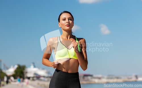 Image of young woman running at seaside