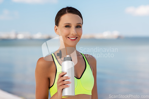 Image of woman drinking water from bottle after sports