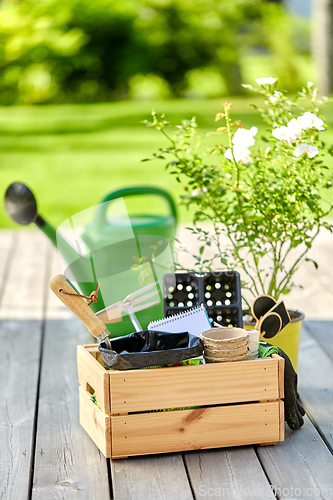 Image of box with garden tools in summer