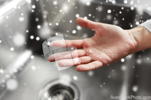Image of close up of clean woman's hand over kitchen sink