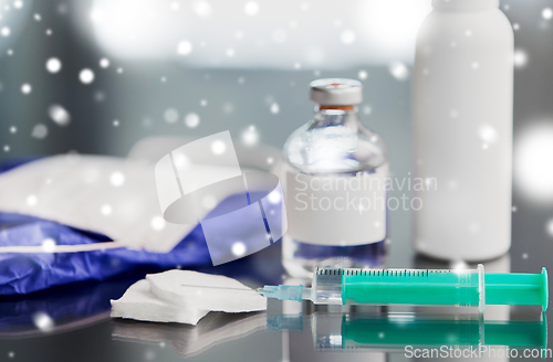 Image of syringe, medicine, wound wipes, gloves and mask