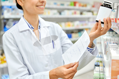 Image of close up of pharmacist with medicine at pharmacy