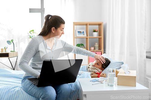 Image of ill daughter and mother with laptop at home