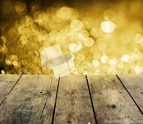 Image of Wooden table with golden lights
