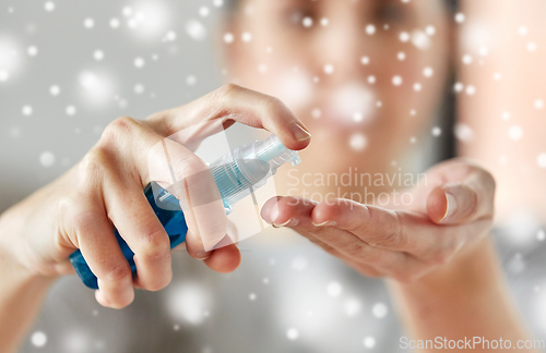 Image of close up of woman spraying hand sanitizer