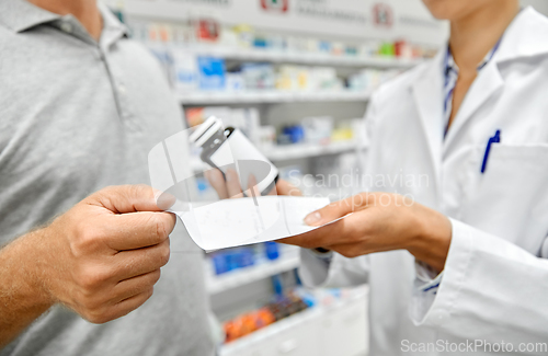 Image of pharmacist and customer with medicine at pharmacy