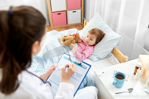 Image of doctor with clipboard and sick girl in bed at home