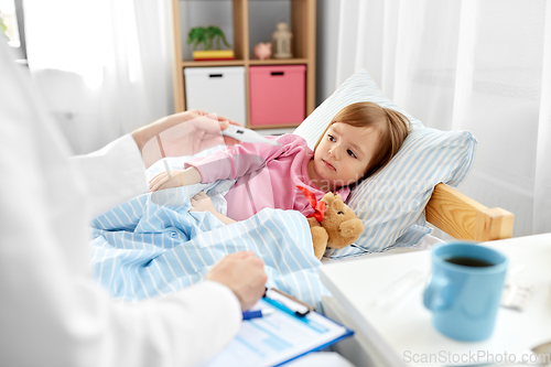 Image of doctor measuring sick girl's temperature