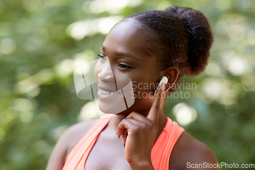 Image of happy african american woman with earphones