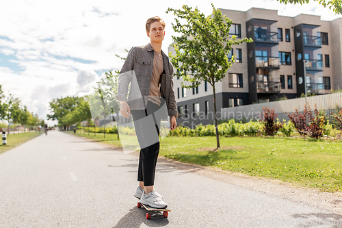 Image of teenage boy on skateboard on city street