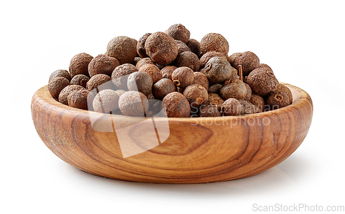 Image of aromatic black pepper in olive wood bowl