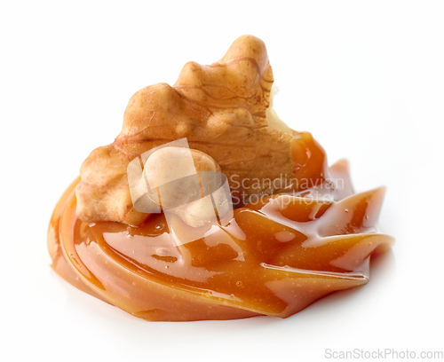 Image of walnut in melted caramel cream