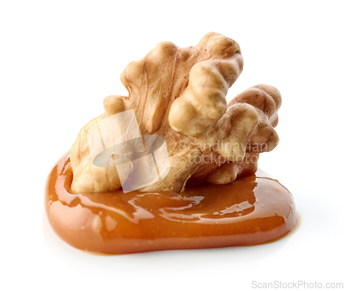 Image of walnut in melted caramel