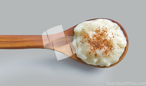 Image of rice and milk pudding in wooden spoon