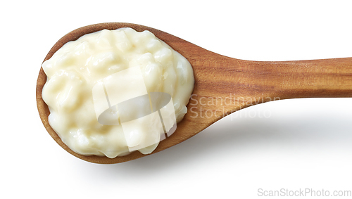 Image of rice pudding in wooden spoon