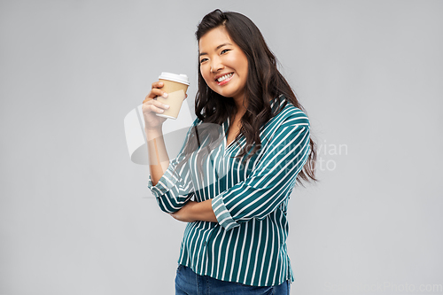 Image of happy asian woman drinking coffee