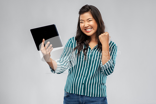 Image of happy asian woman with tablet pc computer