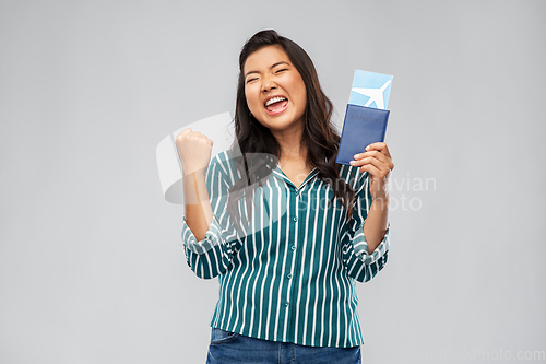 Image of happy asian woman with air ticket and passport