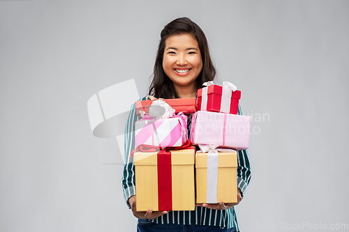 Image of happy asian woman with birthday presents