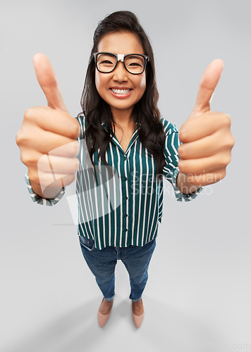 Image of happy asian student woman showing thumbs up