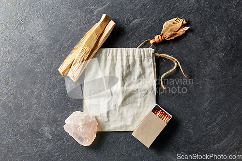 Image of palo santo sticks, bag, quartz crystal and matches