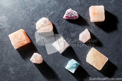 Image of quartz crystal pyramid and gem stones on slate