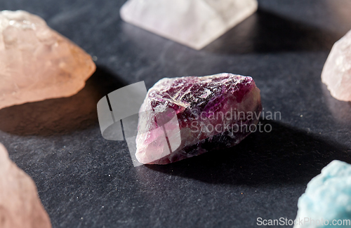 Image of quartz crystals and gem stones on slate background