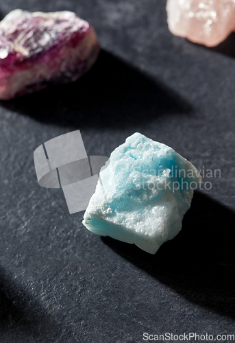 Image of quartz crystals and gem stones on slate background