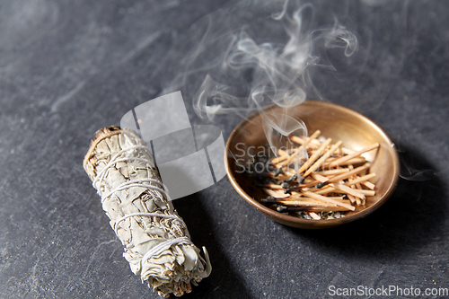 Image of white sage and cup with smoking matches