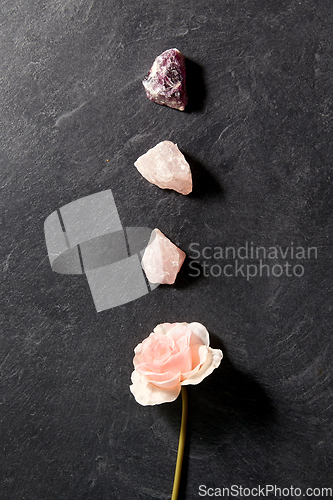 Image of quartz crystals, gem stones and rose flower