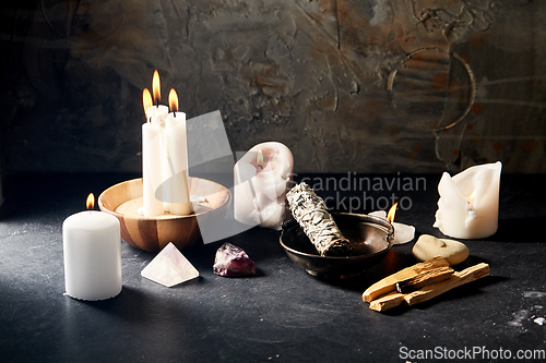 Image of burning candles and various staff for magic ritual