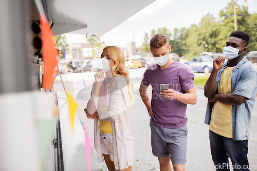 Image of customers in masks at food truck
