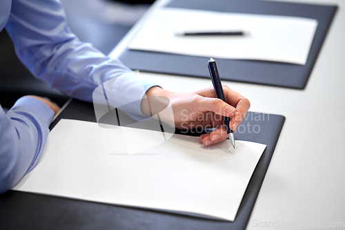 Image of close up of businesswoman with paper at office